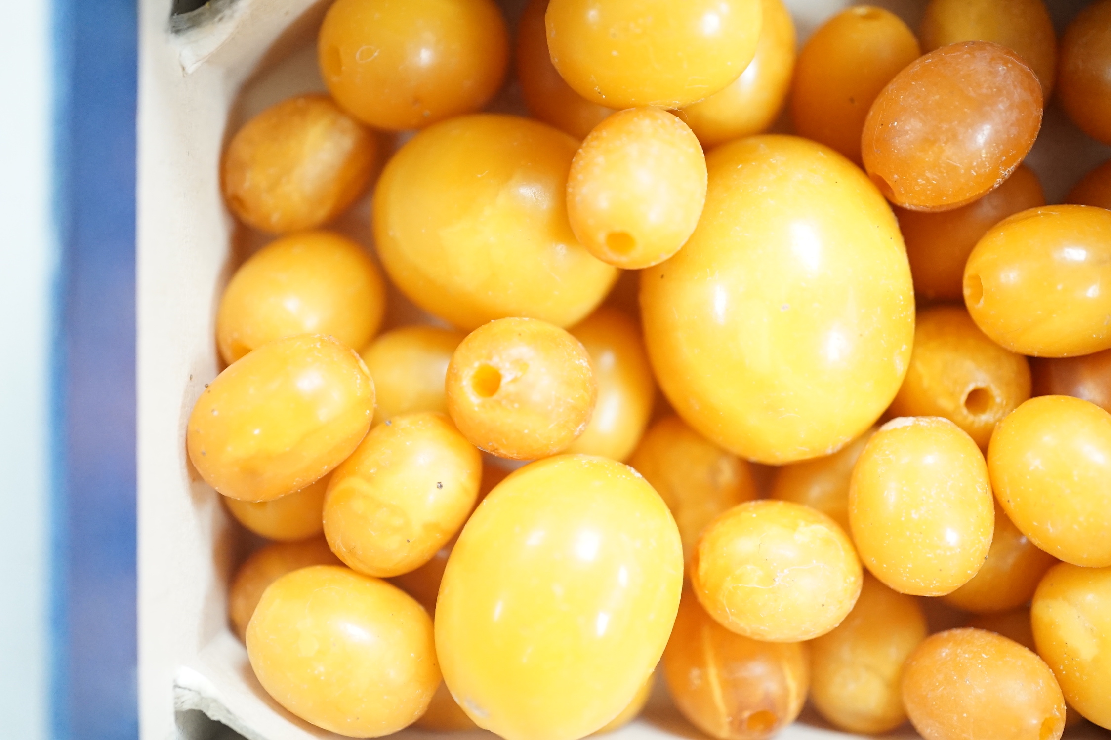 A group of loose graduated oval amber beads, 42 grams.